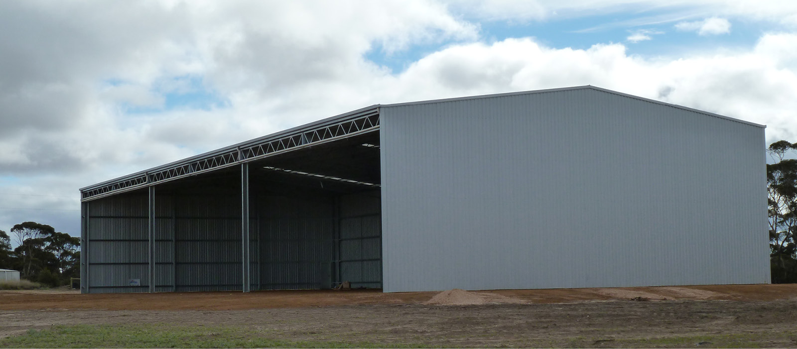 Open Front Rural Machinery Shed in Grass Patch